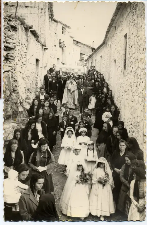 Procesión del Corpus con niñas y niños de Primera Comunión a su paso por la calle de las Escuelas. 1954. Santa Cruz de Moya (Cuenca). Fondo Los Legados de la Tierra. Archivo de la Imagen de Castilla-La Mancha.