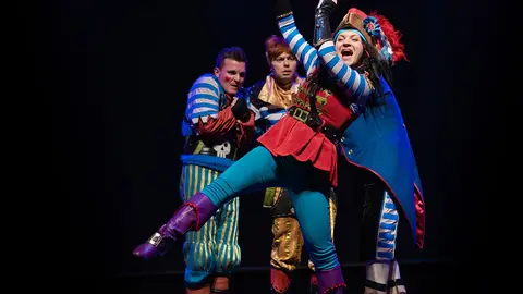 Actors in pirate costumes play a performance for children on the theater stage